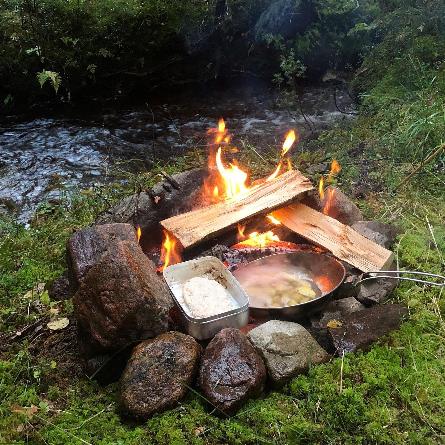campfire besides river