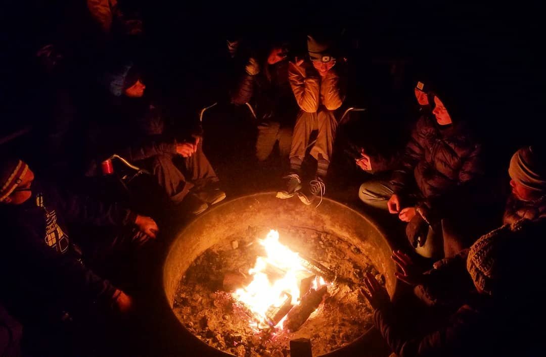 group campers around campfire