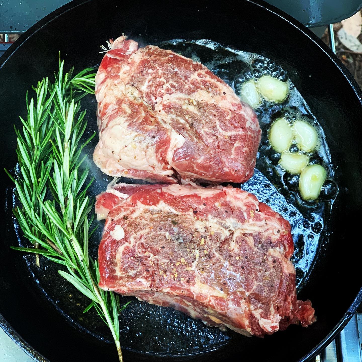 cooking steaks in pan