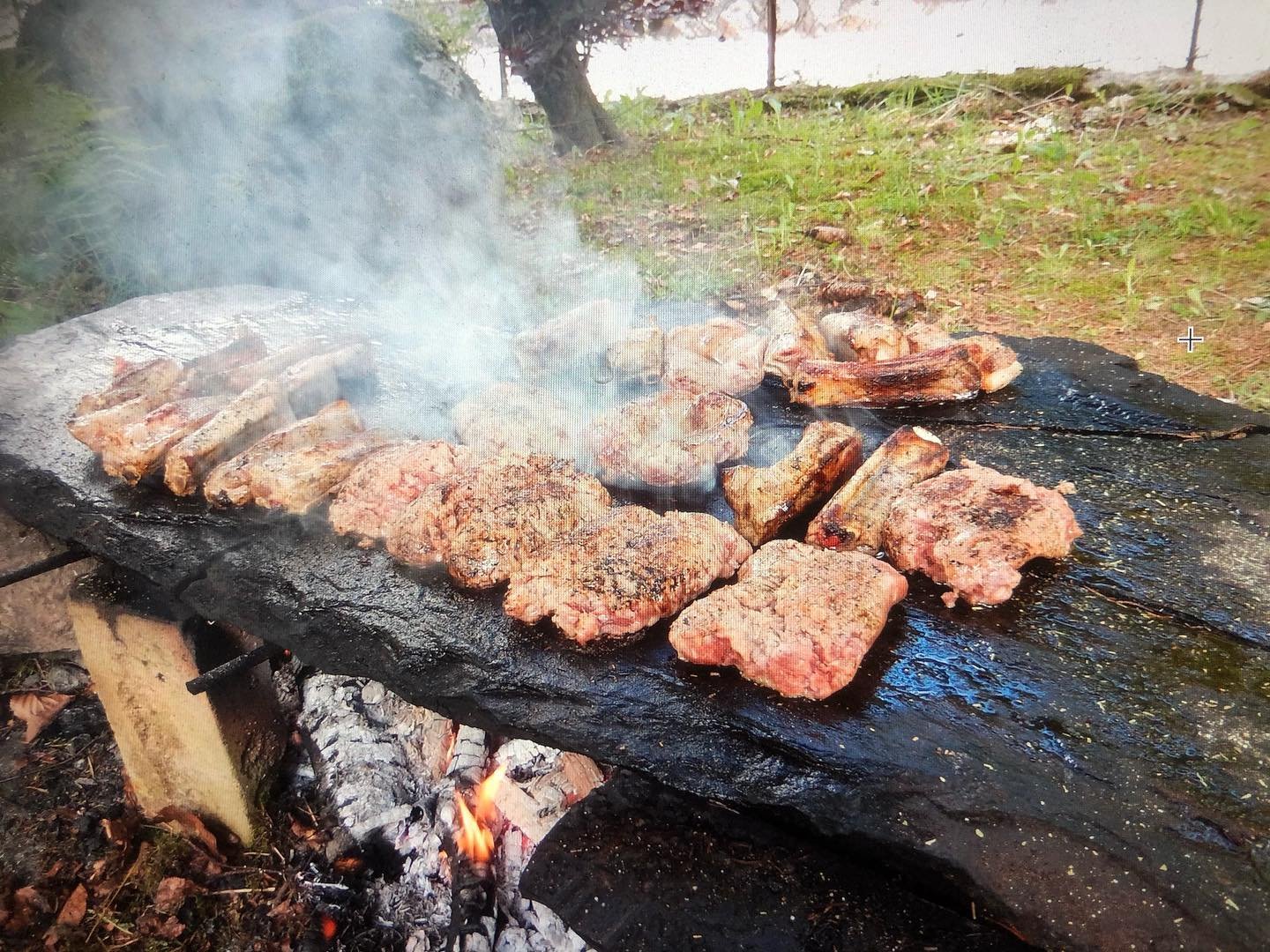 steaks cooking on slab