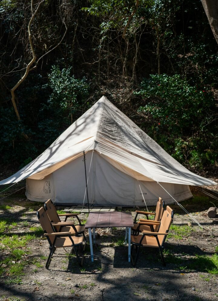 camping tent with wooden chairs