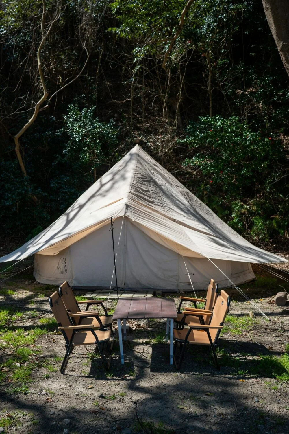 camping tent with wooden chairs